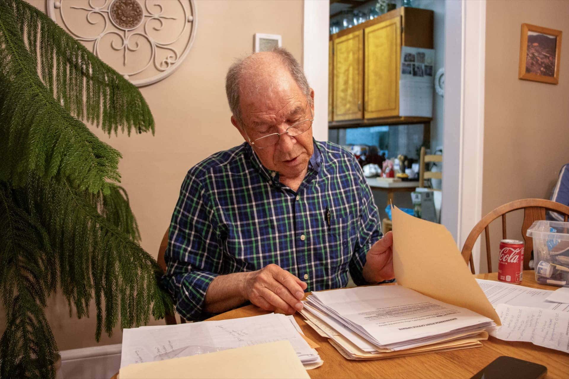 man looks through papers in folder