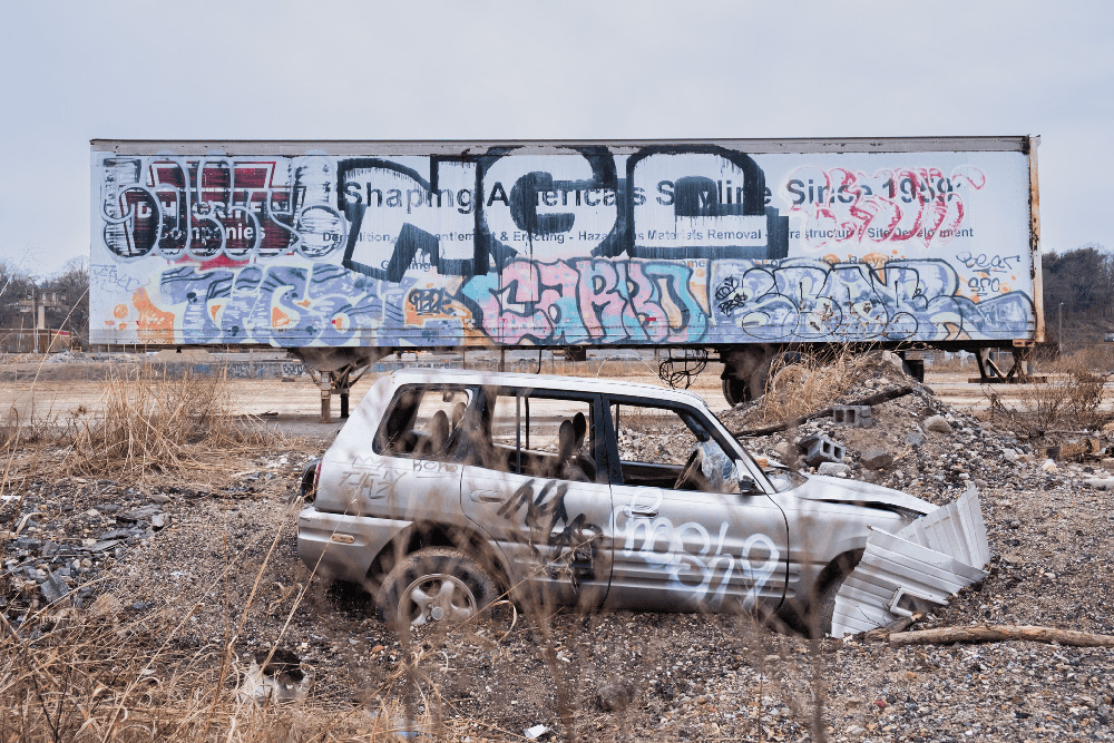 In the River Arts District along the French Broad River in Asheville, a car displaced from the storm is buried beneath debris and dirt.