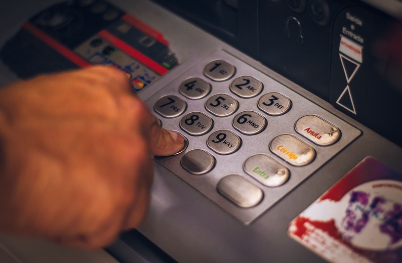 Deposits And Withdrawals At Golden Mister Casino For UK Players Person using a laptop to manage online casino account with a debit card nearby
