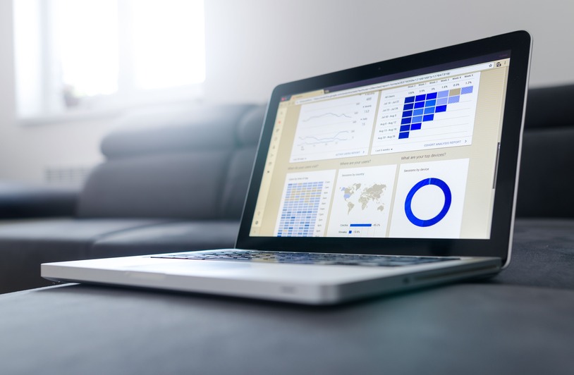 IT professional reviewing asset management data on a computer screen in an office setting