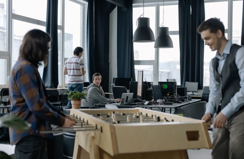 Employees working in a bright modern open-plan office with natural light