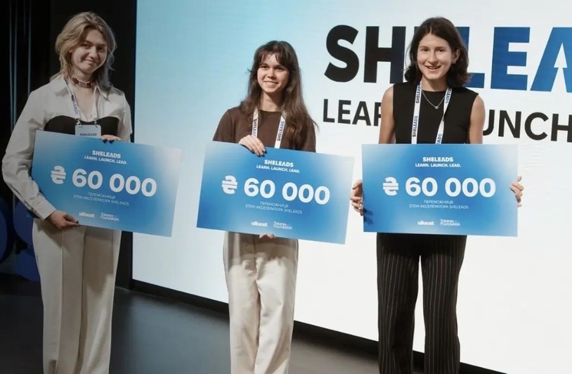 DCR-sheleads-tokarev-foundation-uboost-Insert1 SheLeads STEM accelerator winners holding ceremonial checks on stage