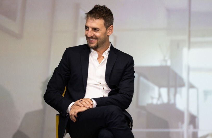 Investing in the Future: The Serhii Tokarev Foundation and uBoost Sum Up SheLeads Professional portrait of a smiling man in a navy blazer and white shirt