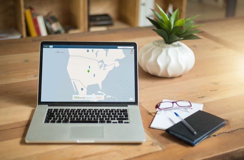 Person using a laptop with a VPN connection active on screen