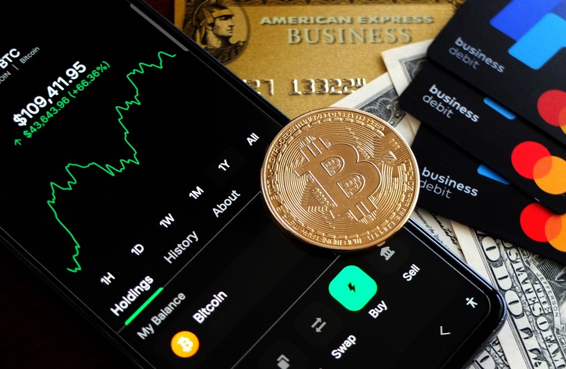 Credit Cards and Bitcoin: What Buyers Should Know Before They Click “Purchase” Bitcoin and credit cards on smartphone for digital trading representation.