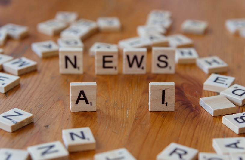 How Legal Representation for Businesses Shapes Ethical AI Adoption and Automation Policies Wooden Scrabble tiles spelling 'AI' and 'NEWS' for a tech concept image.