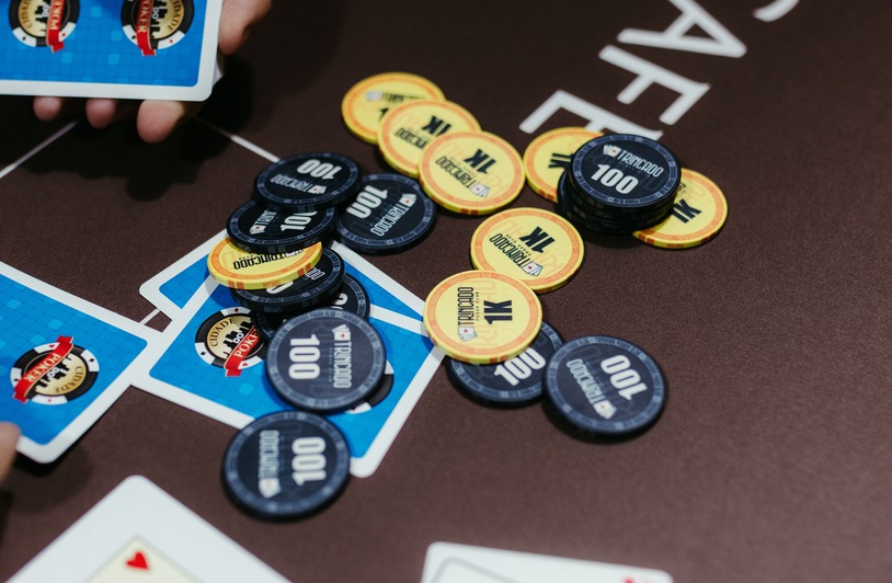 How Online Poker Growth Reduces Live Casino Attendance A close-up of poker chips and cards on a table during a game of Texas Hold'em.