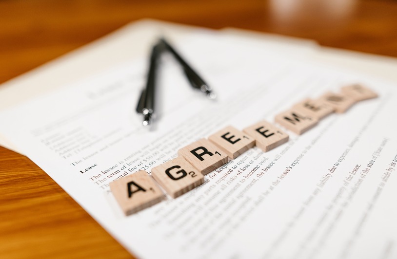 How Reinstatement and Probation Terms Are Negotiated After License Suspension Scrabble tiles spelling 'AGREEMENT' on a lease document, emphasizing contractual themes.