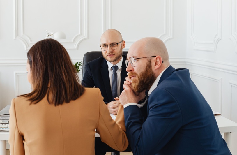 Key Things to Know About Attorney-Client Privilege Lawyers consulting with clients in a modern office setting, discussing legal matters.