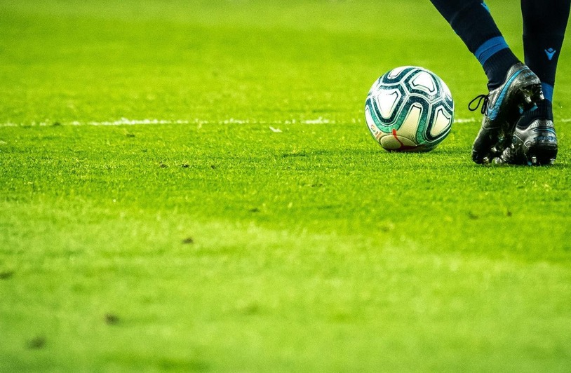 Soccer player in action on a green field during a match