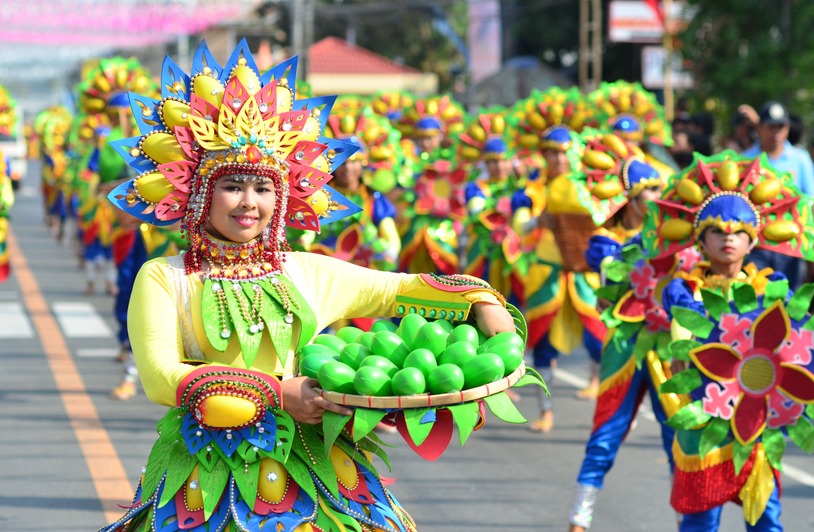 The Perya Color Game: Bridging Tradition and Technology in Filipino Culture Colorful costumes and smiles at the Dinamulag Mango Festival parade in Zambales, Philippines.