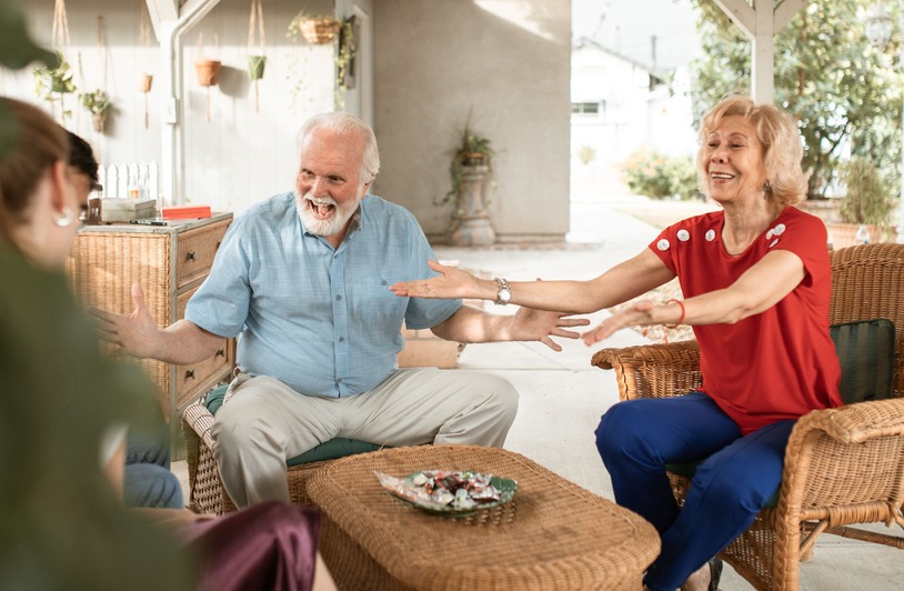 The Surprising Choices Seniors Are Making To Stay Independent Longer Happy senior couple having a lively chat on the patio with family.