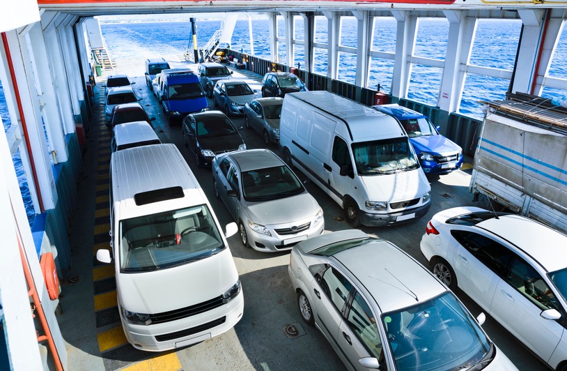 5 Tips on Choosing the Right Car Shipper for You in Milwaukee Vehicles onboard a ferry crossing the ocean, showcasing maritime transport and travel.