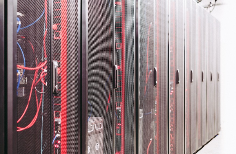 Rows of illuminated server racks inside a modern data center facility
