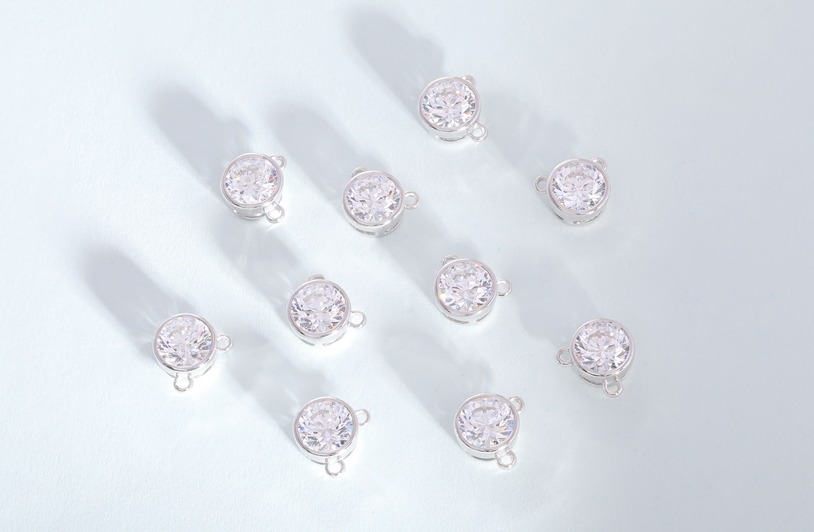 What to Look for When Sourcing Sterling Silver Charms Wholesale Luxurious diamond studs displayed in a minimalistic studio setup. Ideal for jewelry promotions.