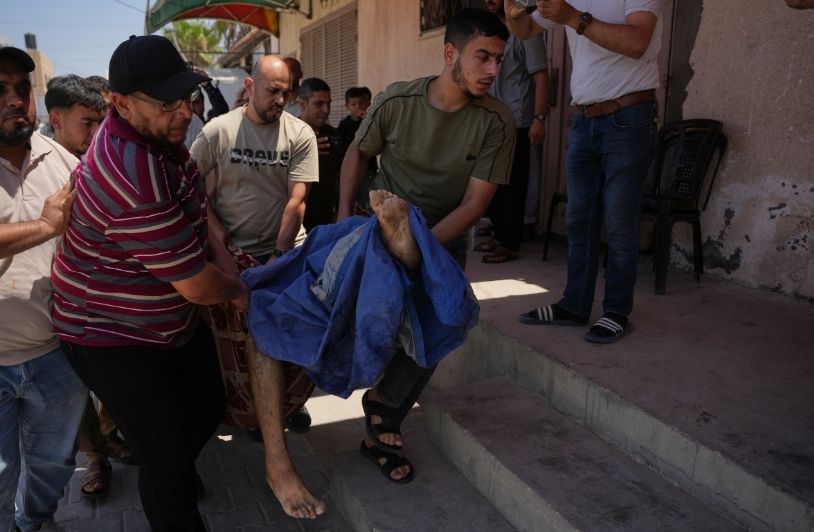 Suddenly, Peace in Gaza? Men carrying a dead body in Gaza