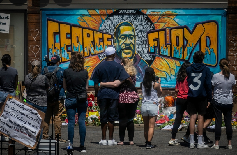 group of people in front of George Floyd mural