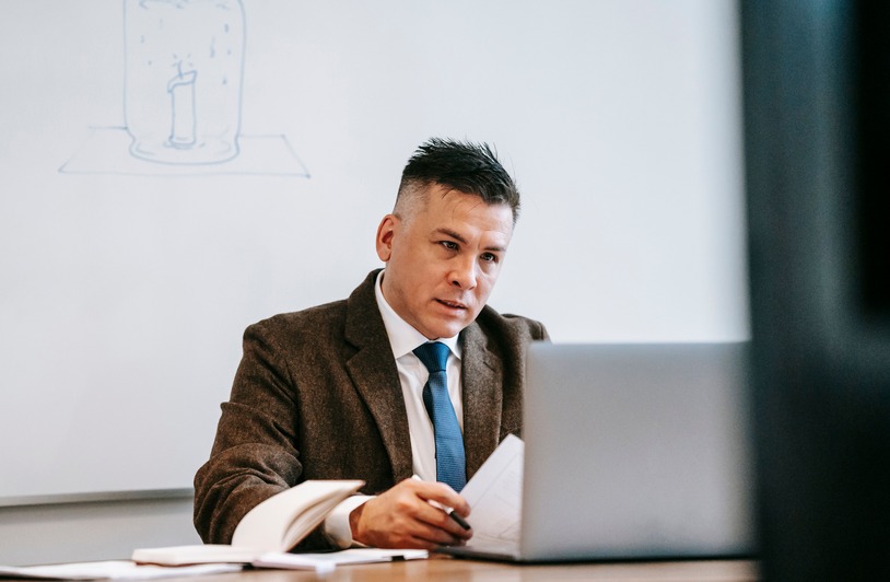 Person completing an online training course on a laptop at a desk