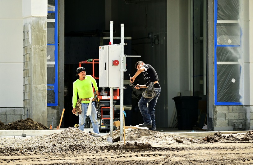 Construction workers in safety gear on a job site