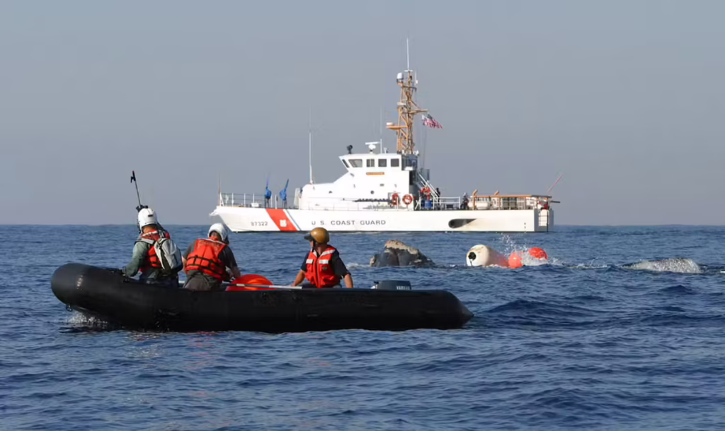People in a rubber boat near the entangled whale.